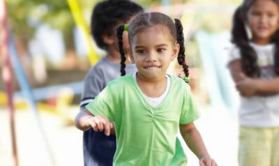 Little girl playing on a  playground